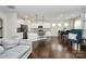 Bright open-concept kitchen with white cabinets, stainless appliances, and center island at 805 Deep River Way, Waxhaw, NC 28173