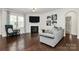 Comfortable living room with fireplace, large windows, and hardwood floors at 805 Deep River Way, Waxhaw, NC 28173