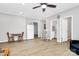 Open-concept living room with wood floors, a full size refrigerator, and furniture at 805 Deep River Way, Waxhaw, NC 28173