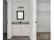 Bright bathroom vanity with granite counters, black fixtures, and framed mirror provides a modern touch at 8057 Cedar Glen Dr, Charlotte, NC 28212