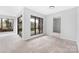 Bedroom with neutral carpet, large windows, and entry doorway at 8057 Cedar Glen Dr, Charlotte, NC 28212