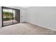 Bedroom with neutral walls, carpet, and access to a patio at 8057 Cedar Glen Dr, Charlotte, NC 28212
