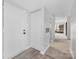 Inviting hallway with wood-look floors, coat closet, and bright, open access to living area at 8057 Cedar Glen Dr, Charlotte, NC 28212