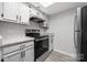 Galley kitchen featuring stainless steel appliances, light gray cabinets and granite countertops at 8057 Cedar Glen Dr, Charlotte, NC 28212
