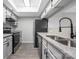 Well-lit kitchen with granite counters, stainless steel appliances, gray cabinets and tile flooring at 8057 Cedar Glen Dr, Charlotte, NC 28212