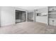 Living room with sliding glass door to patio, neutral carpet, and kitchen pass through at 8057 Cedar Glen Dr, Charlotte, NC 28212