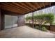 This covered patio offers views of surrounding landscape with privacy bushes and easy indoor-outdoor access at 8057 Cedar Glen Dr, Charlotte, NC 28212