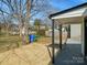 View of a wooden back porch and spacious backyard, featuring mature trees and a well-maintained lawn at 811 Austin St, Albemarle, NC 28001