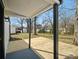 Covered wooden back porch overlooking a spacious backyard with mature trees at 811 Austin St, Albemarle, NC 28001