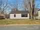 Side view of a charming house with a black roof and large window at 811 Austin St, Albemarle, NC 28001