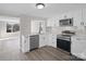 Well-lit kitchen featuring white cabinets, stainless steel appliances, and gray subway tile backsplash at 811 Austin St, Albemarle, NC 28001