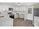 Well-lit kitchen with white cabinets, modern appliances, and an adjacent side door for easy access at 811 Austin St, Albemarle, NC 28001