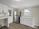Bright kitchen featuring white cabinets, stainless steel refrigerator, and convenient side entrance at 811 Austin St, Albemarle, NC 28001