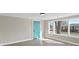 Bright living room with a modern blue front door and abundant natural light from several windows at 811 Austin St, Albemarle, NC 28001