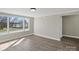 Well-lit living room with large windows and modern flooring, ready for your personal touch at 811 Austin St, Albemarle, NC 28001