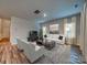 Bright living room featuring hardwood floors, neutral walls, and comfortable seating at 8632 Pennegrove Cir, Charlotte, NC 28214