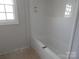 Clean bathroom featuring a new tub, plywood floor, and fresh paint, creating a bright and welcoming space at 915 Chapel St, Landis, NC 28088