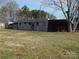 Rustic outbuilding with ample storage space, and a view of the expansive lot at 915 Chapel St, Landis, NC 28088