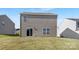 A large, grassy backyard features sliding glass doors and windows on the rear of the home at 1011 20Th Avenue Se Loop, Hickory, NC 28602