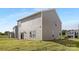 A large, grassy backyard with a view of the house featuring sliding glass doors and windows at 1011 20Th Avenue Se Loop, Hickory, NC 28602