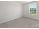 Bright bedroom with a large window overlooking a green outdoor area at 1011 20Th Avenue Se Loop, Hickory, NC 28602
