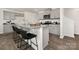 Modern kitchen featuring gray cabinetry, granite countertops, and bar seating, perfect for casual dining at 1011 20Th Avenue Se Loop, Hickory, NC 28602