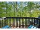 Enjoy outdoor living on the balcony with chairs overlooking lush greenery and serene water views at 106 Mcnaron Ln, Mooresville, NC 28117