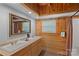 Bathroom features wood trim, a double sink vanity, large mirror, and plenty of lighting at 106 Mcnaron Ln, Mooresville, NC 28117