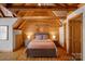 Cozy bedroom with wood ceiling, modern furniture, and a door leading to an attached bathroom at 106 Mcnaron Ln, Mooresville, NC 28117