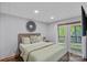 Comfortable bedroom with French doors leading to a balcony and a modern design at 106 Mcnaron Ln, Mooresville, NC 28117