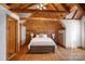 Striking bedroom featuring vaulted wood ceiling, exposed beams, and rustic wood finishes at 106 Mcnaron Ln, Mooresville, NC 28117
