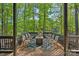 Lakeside deck with ample seating and fire pit overlooking the serene lake and lush trees at 106 Mcnaron Ln, Mooresville, NC 28117