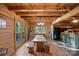 Rustic dining room with a wooden table, bench seating, and views of the outdoors at 106 Mcnaron Ln, Mooresville, NC 28117