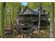 Stunning log home with multiple decks nestled among the trees in a tranquil setting at 106 Mcnaron Ln, Mooresville, NC 28117