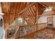 View of the wooden hallway with open ceilings overlooking the living area, adding a unique architectural design at 106 Mcnaron Ln, Mooresville, NC 28117
