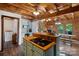 Bright kitchen with wood ceiling, island cooktop, breakfast bar, and open access to dining area at 106 Mcnaron Ln, Mooresville, NC 28117