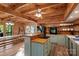 Spacious kitchen with wood ceiling, island cooktop, stainless oven, and breakfast bar at 106 Mcnaron Ln, Mooresville, NC 28117