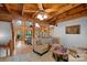 Open-concept living room featuring exposed wood beams, stone fireplace, and natural light at 106 Mcnaron Ln, Mooresville, NC 28117
