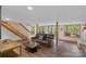 Spacious basement living area featuring wood floors, staircase, and comfortable seating area at 106 Mcnaron Ln, Mooresville, NC 28117