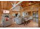 Cozy living room featuring a stone fireplace, exposed beams, and an open floor plan at 106 Mcnaron Ln, Mooresville, NC 28117
