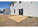 Backyard view with a concrete patio, sliding glass door, and white siding at 107 Megby Trl, Statesville, NC 28677