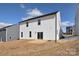 Backyard view with a concrete patio, sliding glass door, and white siding at 107 Megby Trl, Statesville, NC 28677