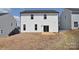 Backyard view with a concrete patio, sliding glass door, and white siding at 107 Megby Trl, Statesville, NC 28677