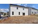 Backyard view with a concrete patio, sliding glass door, and white siding at 107 Megby Trl, Statesville, NC 28677
