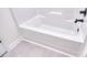 Bathtub with tile flooring and new fixtures at 107 Megby Trl, Statesville, NC 28677