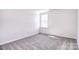 Bright bedroom featuring neutral carpet, one window and fresh white walls at 107 Megby Trl, Statesville, NC 28677
