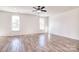 Spacious bedroom with neutral walls, hardwood floors, and two windows providing natural light at 107 Megby Trl, Statesville, NC 28677