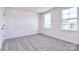 Bright bedroom featuring neutral carpet, two windows and fresh white walls at 107 Megby Trl, Statesville, NC 28677