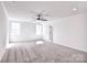 Bright bedroom featuring neutral carpet, ceiling fan and two windows at 107 Megby Trl, Statesville, NC 28677