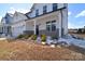 Exterior view of a two-story home with a covered front porch and nicely landscaped front yard at 107 Megby Trl, Statesville, NC 28677